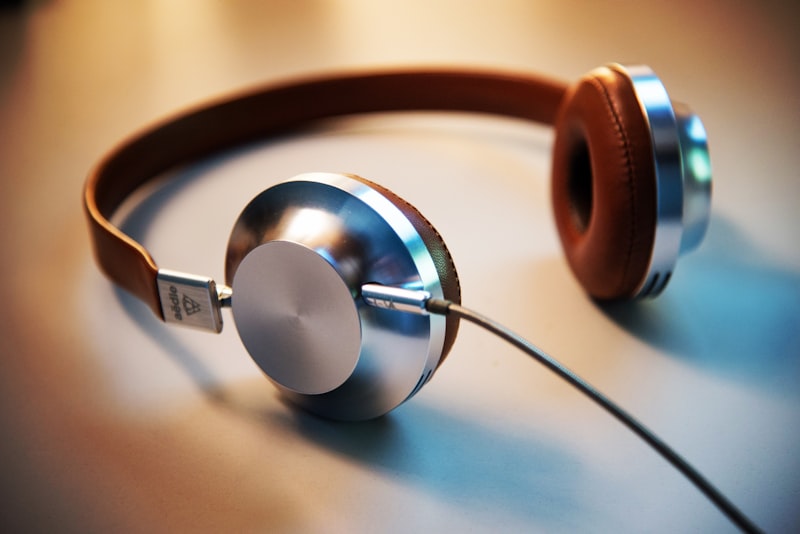 Over-ear headphones resting on a wooden desk