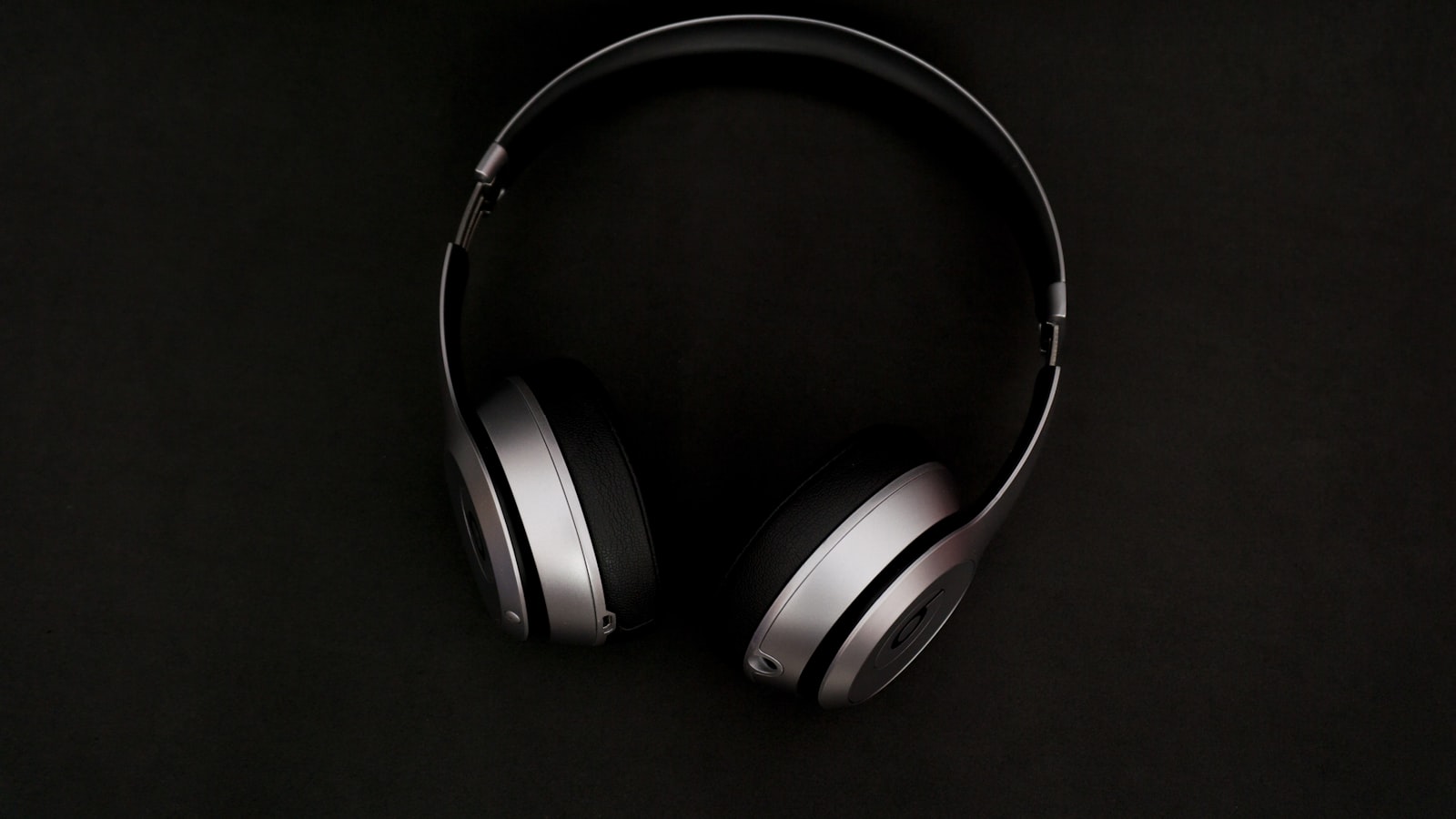 Headphones beside an audio equalizer interface