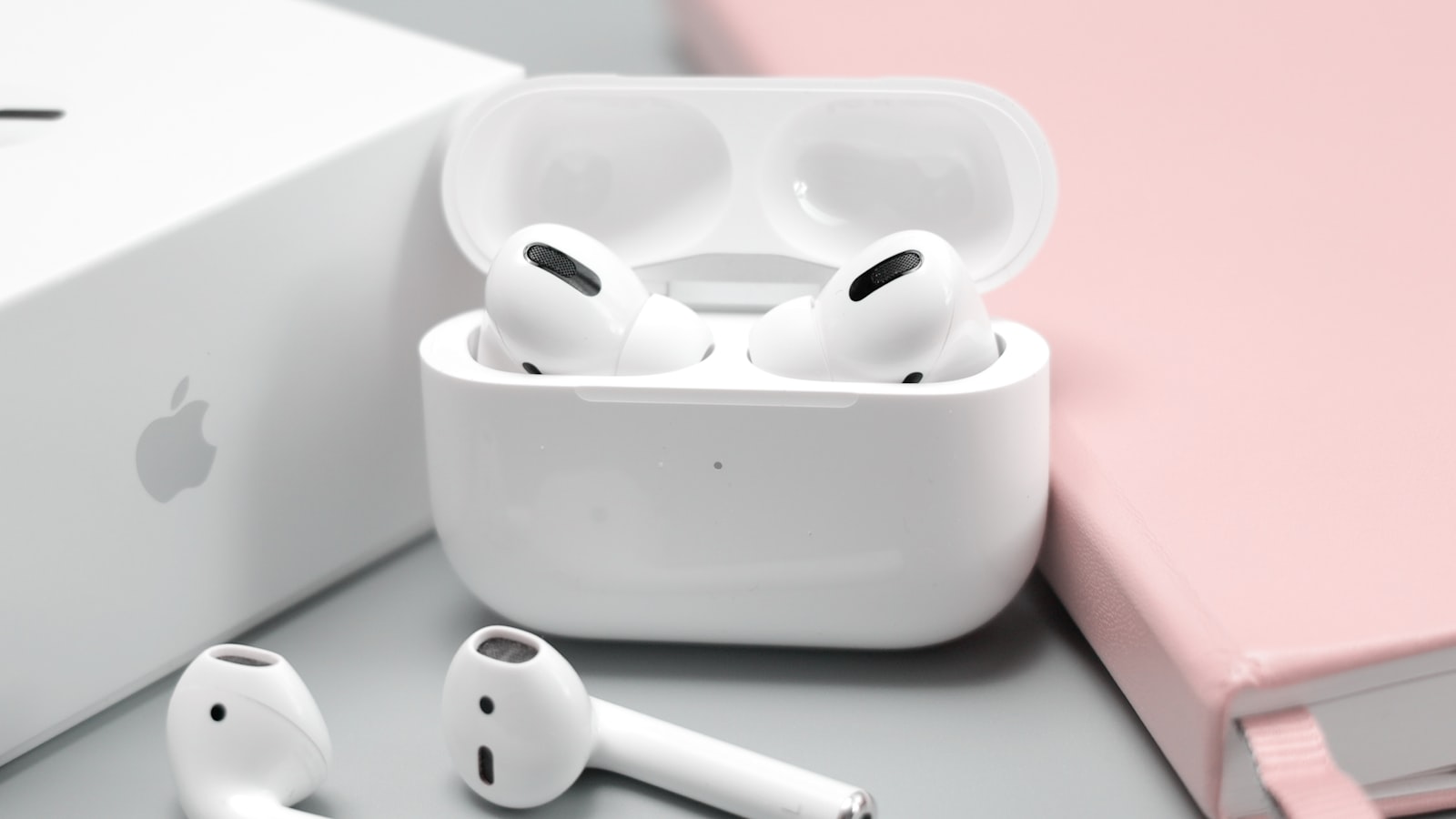 Over-ear headphones next to wireless earbuds